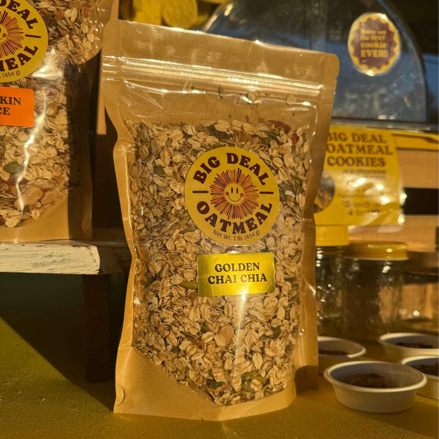 Packaged golden chia seeds with 'Big Deal Oatmeal' branding on a table.